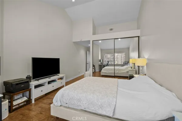 a bedroom with a bed tv and table