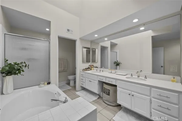 a spacious bathroom with a double vanity sink and a large mirror