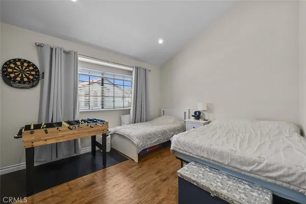 a bedroom with two beds and a desk
