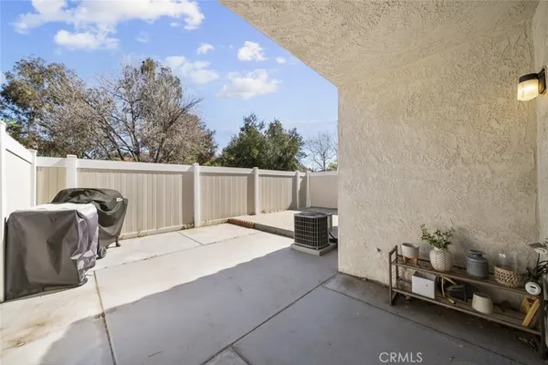 a backyard of a house with table and chairs