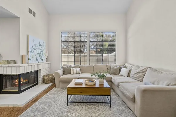 a living room with furniture and a fireplace