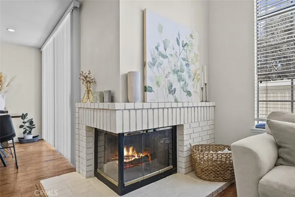 a living room with furniture a fireplace and a table