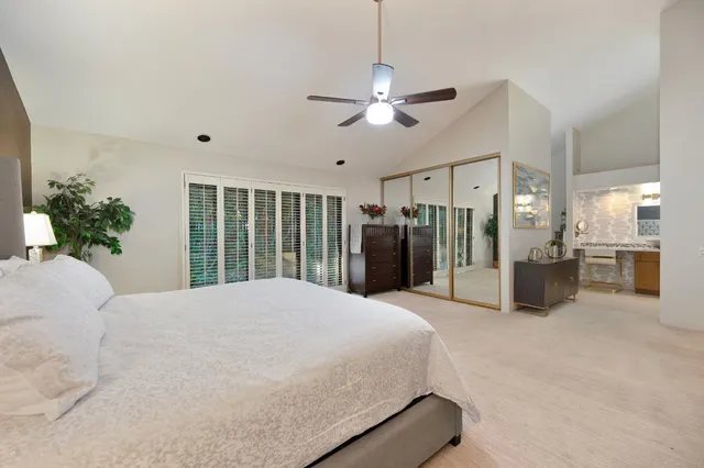 a large bed sitting in a room next to a window