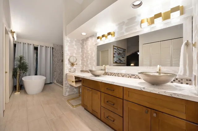 a spacious bathroom with a granite countertop sink and a mirror