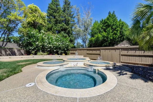 a view of a swimming pool with a yard