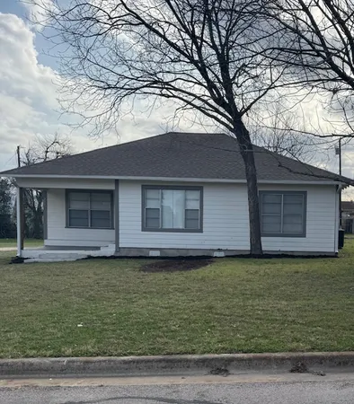a house that has a big yard with wooden fence