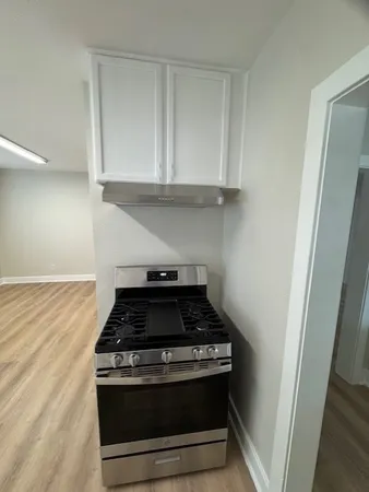a stove top oven sitting inside of a kitchen