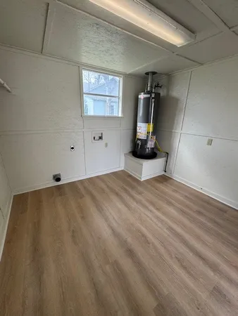 a view of a room with wooden floor and window