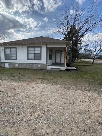 a view of a house with a garden and deck