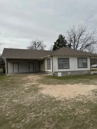 a house that has a tree in front of it