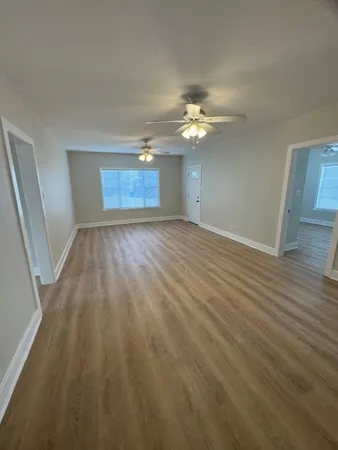 wooden floor in an empty room with a window