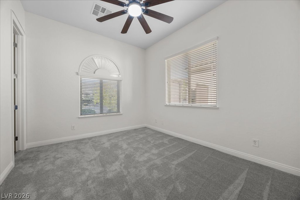 2125 De Rouge Avenue Henderson, NV 89044 - Photo 61 of 96 Natural light streams into this serene bedroom, offering comfort and style.