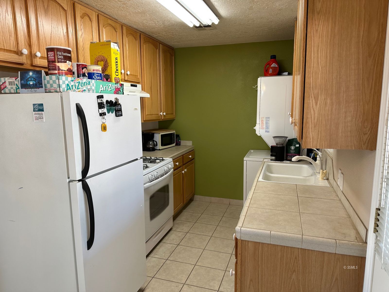 237 South Desert Candles Street Ridgecrest, CA 93555 - Photo 8 of 23 a kitchen with stainless steel appliances a refrigerator sink and cabinets