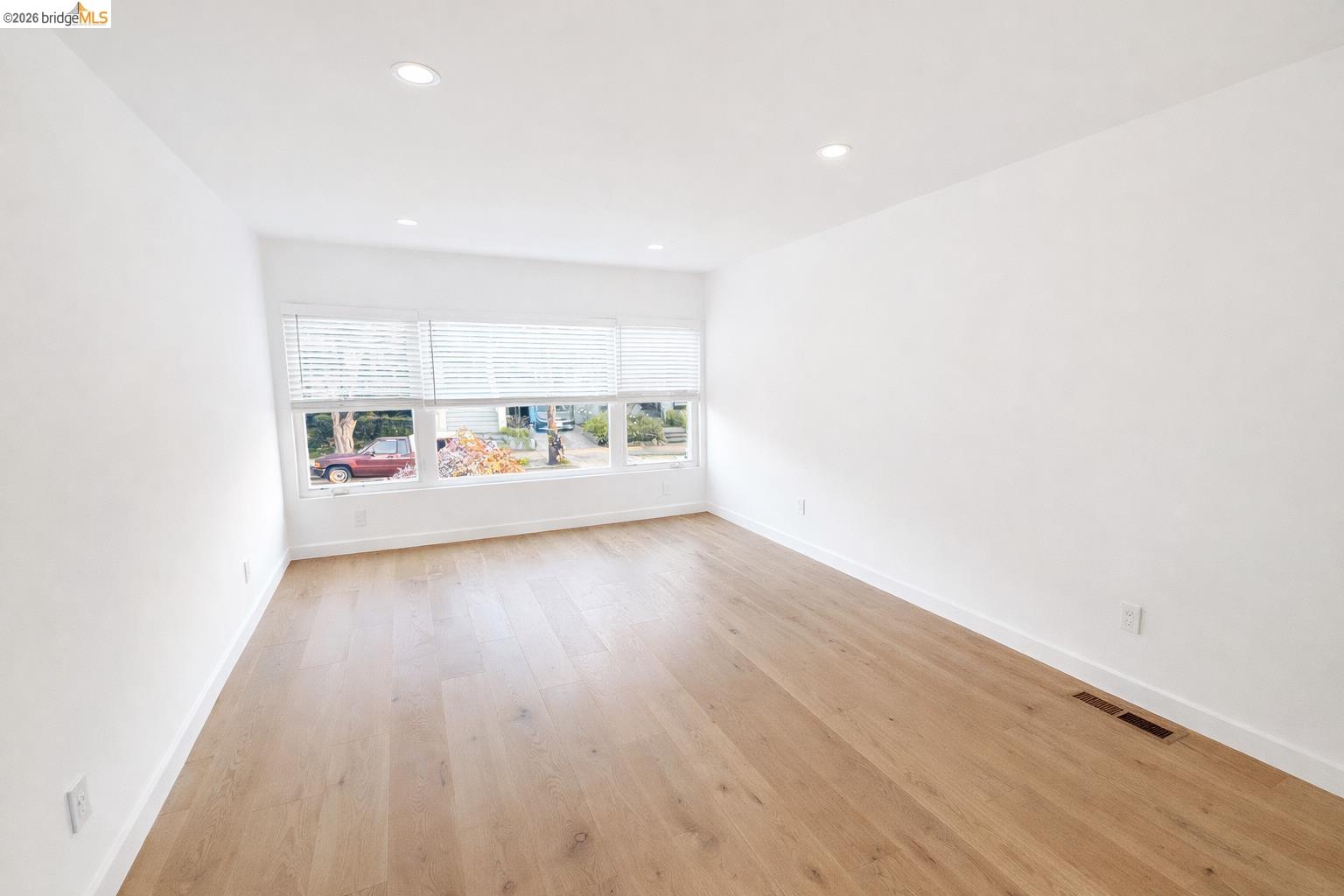 2045 Emerson Street Berkeley, CA 94703 - Photo 12 of 19 an empty room with wooden floor and windows