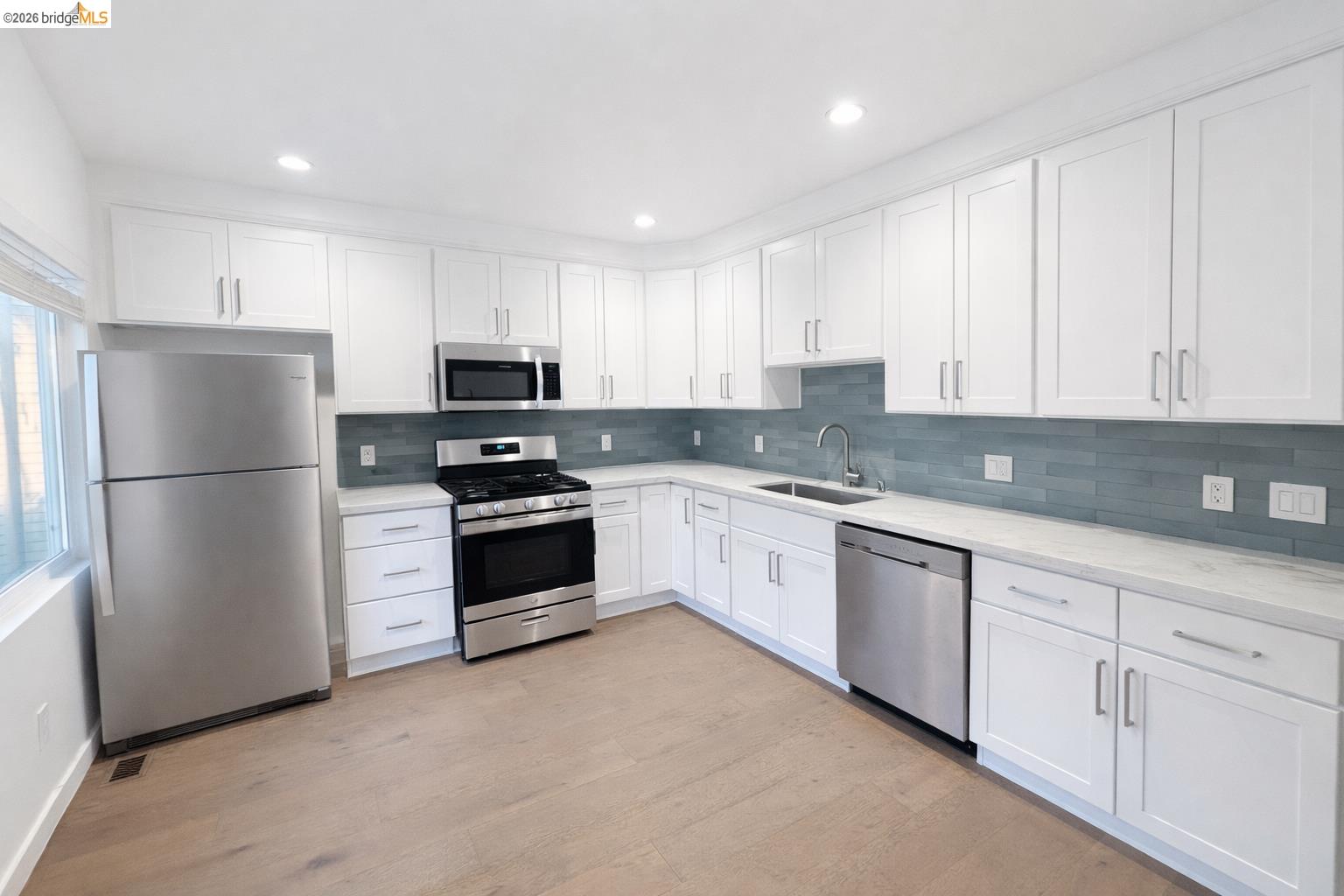 2045 Emerson Street Berkeley, CA 94703 - Photo 7 of 19 a kitchen with granite countertop white cabinets and stainless steel appliances