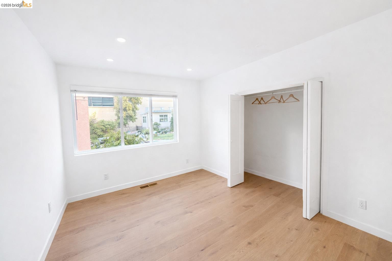 2045 Emerson Street Berkeley, CA 94703 - Photo 9 of 19 an empty room with wooden floor and windows