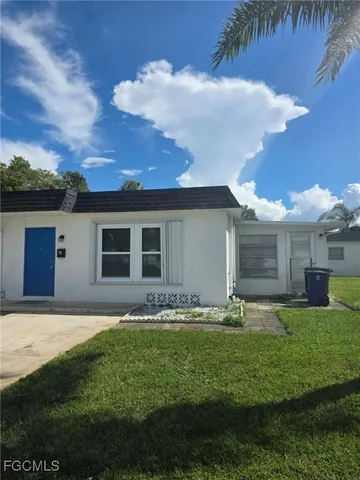 a front view of house with yard and outdoor seating