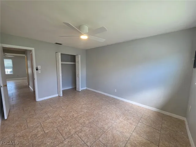 an empty room with windows and bathroom view
