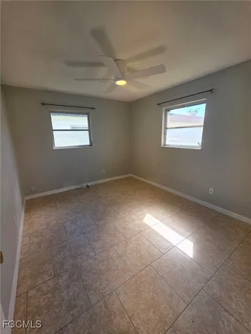 an empty room with a empty space and windows