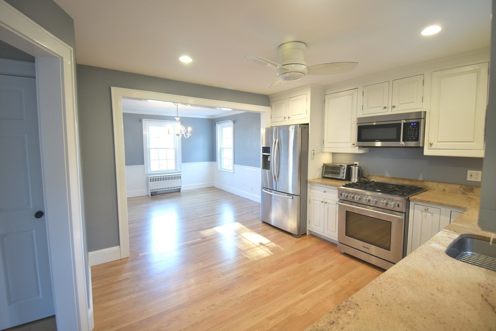 164 Florence Road Waltham, MA 02453 - Photo 3 of 19 a kitchen with stainless steel appliances a stove a refrigerator sink and microwave