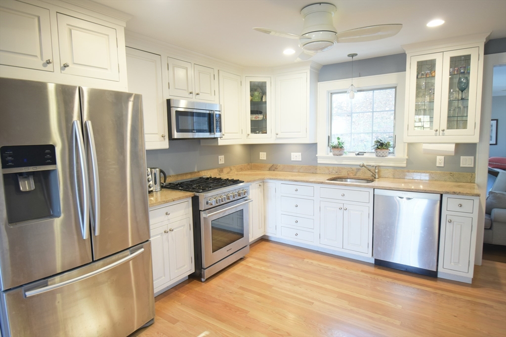 164 Florence Road Waltham, MA 02453 - Photo 4 of 19 a kitchen with granite countertop a refrigerator stove and sink