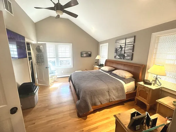 a bedroom with a bed and wooden floor