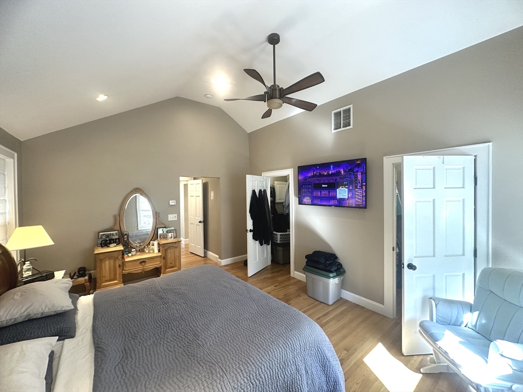 164 Florence Road Waltham, MA 02453 - Photo 8 of 19 a bedroom with a bed and a chandelier