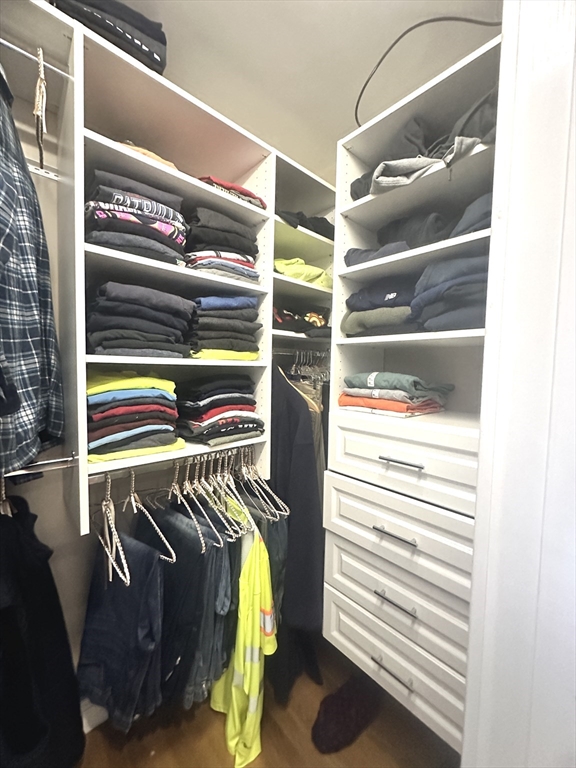 164 Florence Road Waltham, MA 02453 - Photo 10 of 19 a view of walk in closet with clothes and shoes