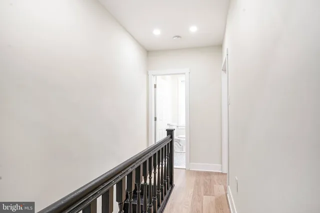 a view of hallway with wooden floor