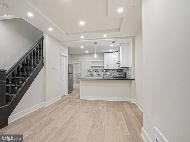 a view of kitchen with sink and refrigerator