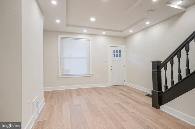 a view of an empty room with wooden floor