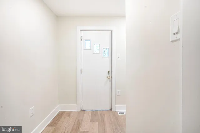 a view of a hallway with wooden floor