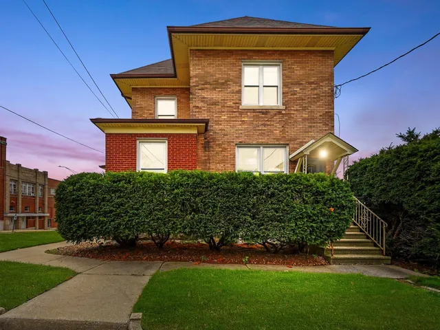 a front view of house with yard and green space