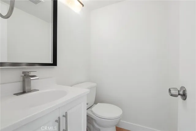 a bathroom with a sink a toilet and mirror