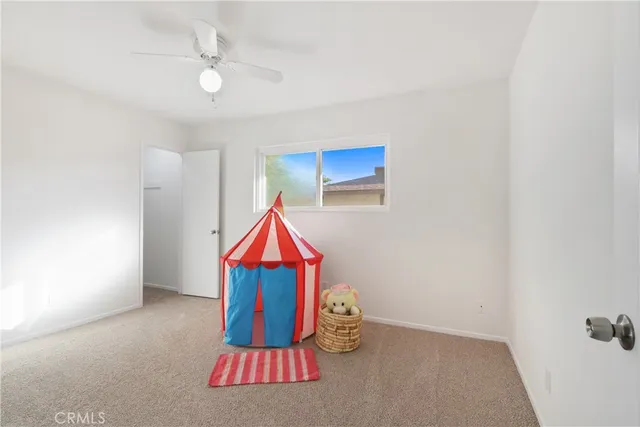 a room with lots of white walls and a chandelier