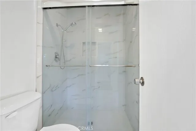 a bathroom with a shower and a toilet