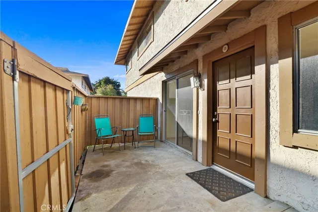a backyard of a house with table and chairs