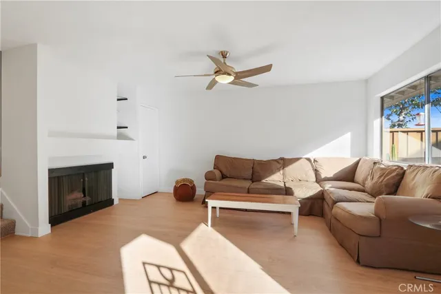 a living room with furniture a fireplace and a window