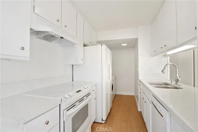 a kitchen with a sink and a refrigerator