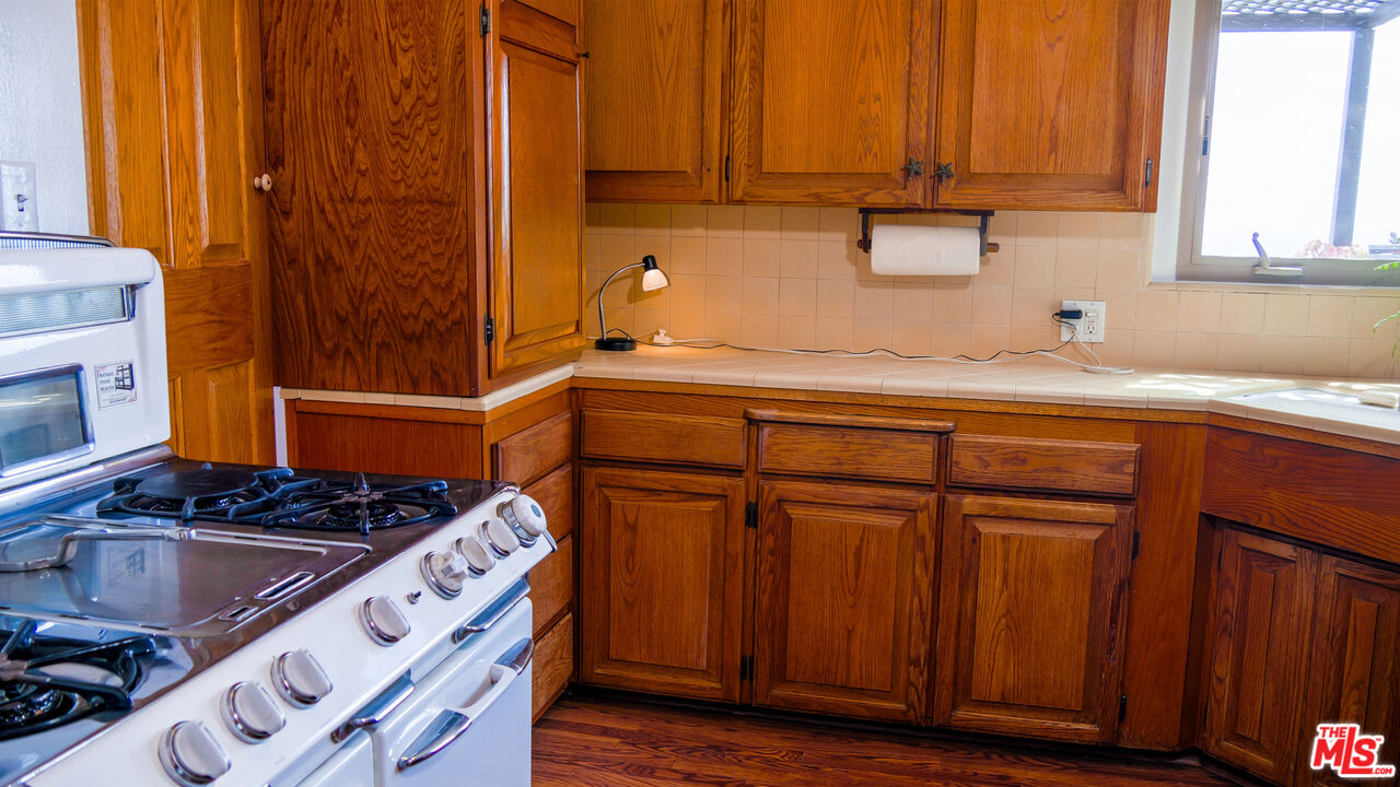 7505 Rindge Avenue Playa del Rey, CA 90293 - Photo 18 of 29 a kitchen with stainless steel appliances granite countertop a sink stove and cabinets