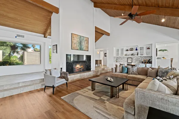 a living room with furniture a fireplace and a table