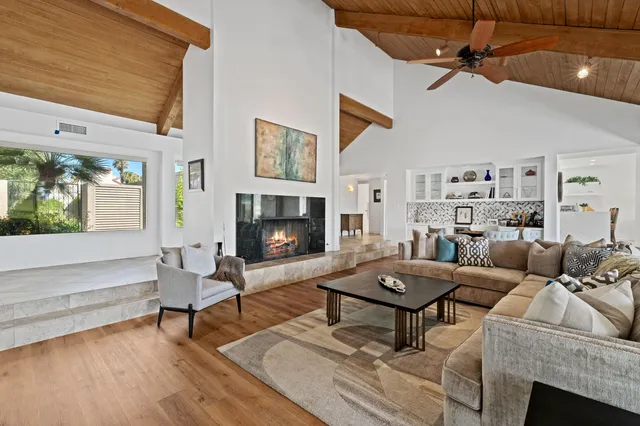 a living room with furniture a fireplace and a table