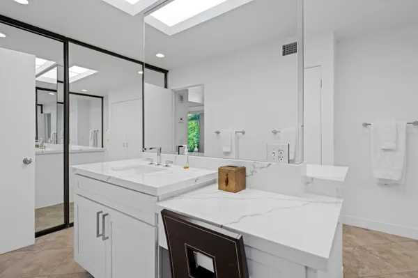 a view of a sink and a refrigerator in a room