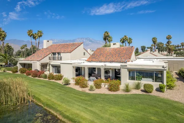 a aerial view of a house with swimming pool garden and outdoor seating