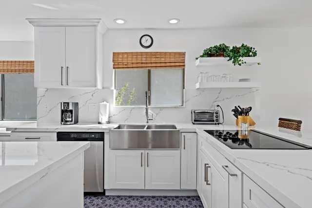 a kitchen with cabinets a sink and appliances