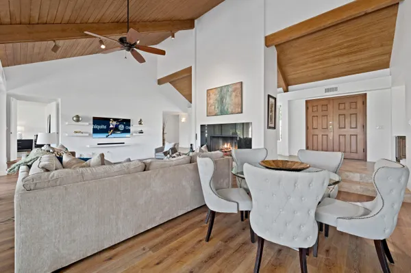 a living room with furniture a fireplace and a flat screen tv
