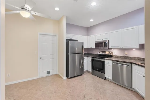 a kitchen with stainless steel appliances granite countertop a stove and a refrigerator