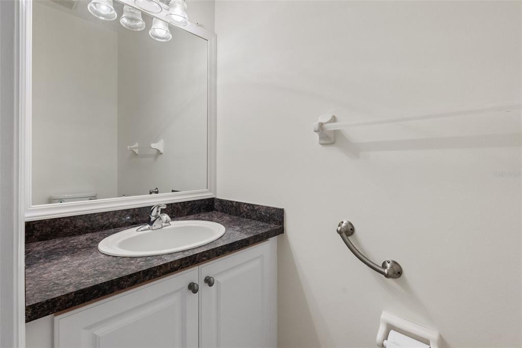 1050 Starkey Road, Unit 704 Largo, FL 33771 - Photo 13 of 27 a sink and a mirror