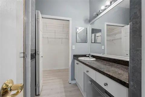 a bathroom with a granite countertop sink a toilet and shower