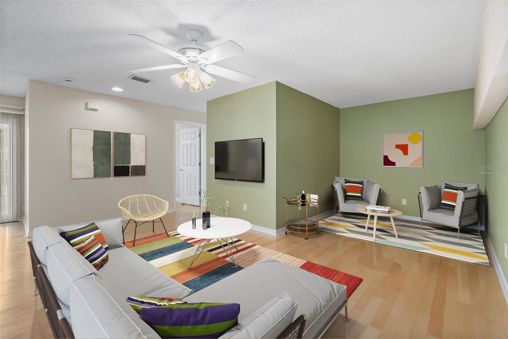 1050 Starkey Road, Unit 704 Largo, FL 33771 - Photo 4 of 27 a living room with furniture and a flat screen tv